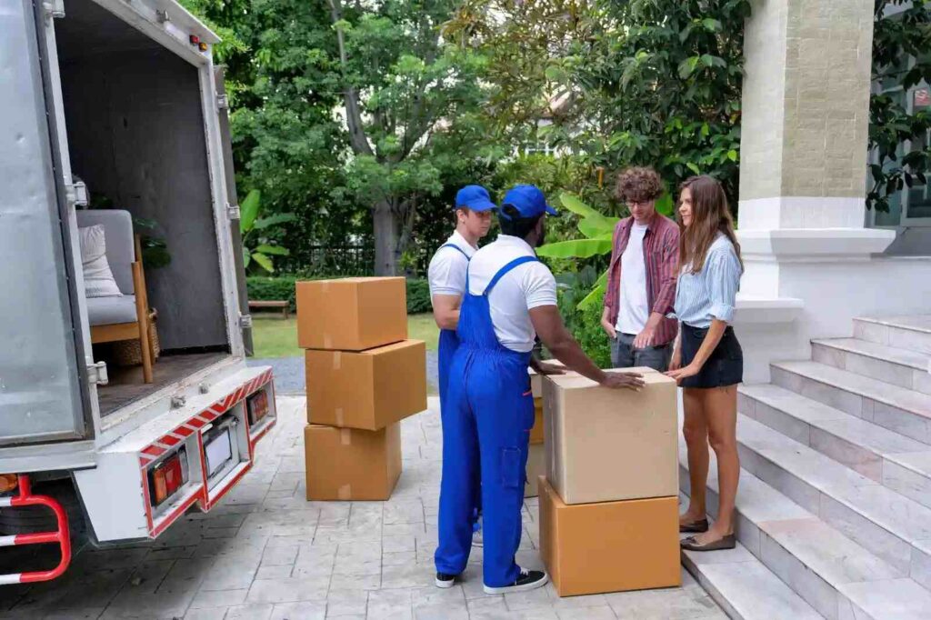 Movers carefully loading furniture into a moving truck, ensuring safe transportation.